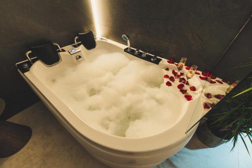 a bath tub with clouds on it in a bathroom at Jacuzzi Siesławska Top Apartment in Busko-Zdrój
