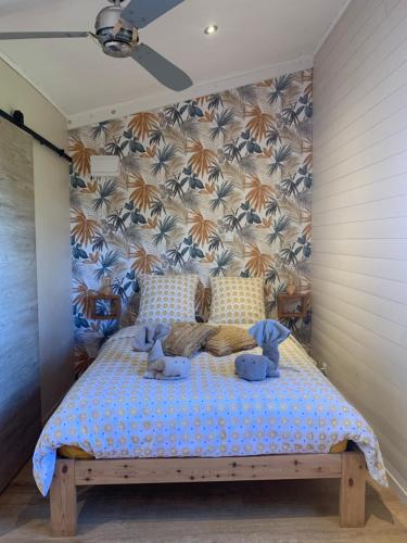 a bedroom with a bed with two stuffed animals on it at studio P ti koin trankil in La Possession