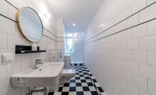 a bathroom with a sink and a mirror at Qwema Guest House in Nairobi