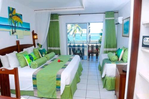 a bedroom with two beds and a view of the ocean at Qwema Guest House in Nairobi
