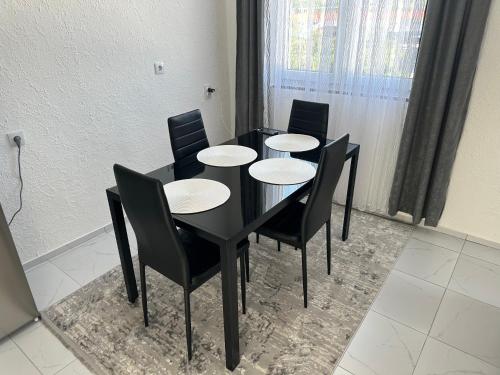 a black dining room table with black chairs at Sarajevo Corner in Gladno Polje