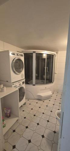 a kitchen with a microwave and a tiled floor at Sia Home in Vålberg
