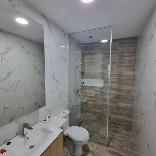 a bathroom with a toilet and a sink and a shower at Lux apartmani boka in Tivat