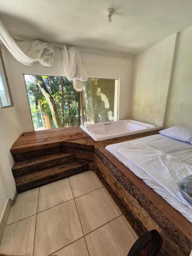 a small room with a bed and a window at pousada do vovo pescador in Juatuba