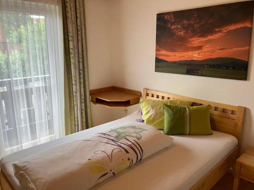 a bed sitting in a bedroom with a window at Gasthaus Mossauer in Feistritz bei Knittelfeld