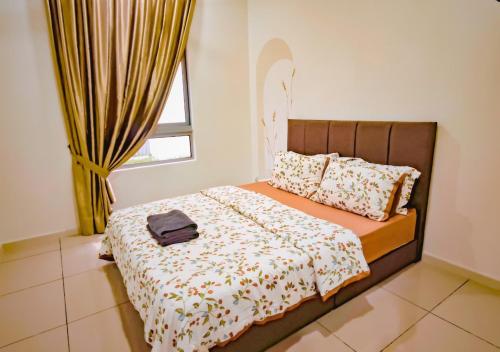 a bedroom with a bed with a bag on it at Gamuda Cove 4BR SplashMania in Banting