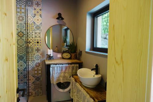 a bathroom with a sink and a mirror at BOHO Forest Retreat in Novo Mesto