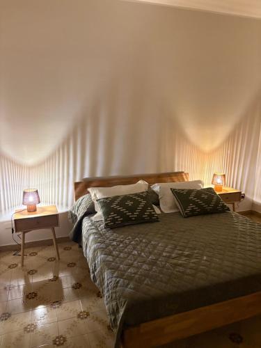 a bedroom with a bed and two lamps on tables at A casa di Rita in Toro