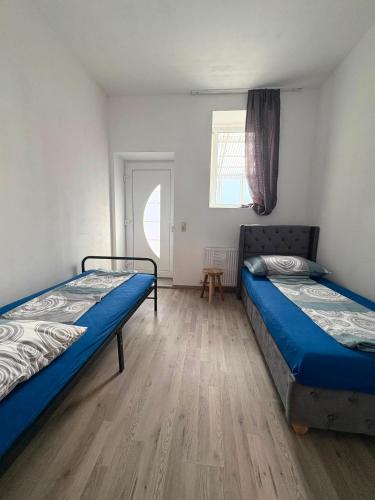 a bedroom with two beds and a wooden floor at Apartment 2 in Golling an der Erlauf in Petzenkirchen