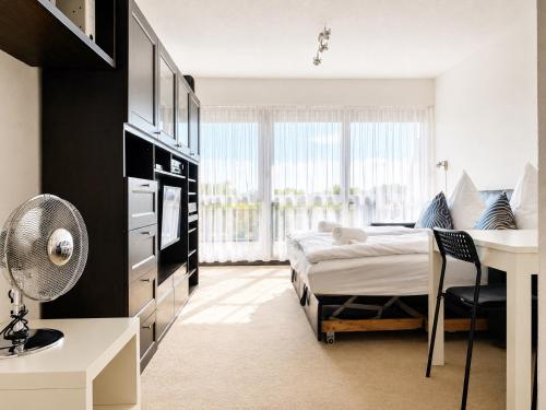 a bedroom with a bed and a desk in a room at Thermenblick in Bad Rodach