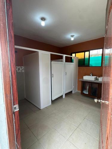 a bathroom with white cabinets and a sink at The Resident 