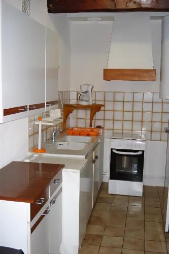 a kitchen with a sink and a stove at Chez ellen in La Tour-dʼAuvergne