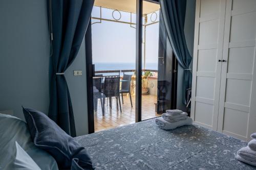 a bedroom with a bed and a view of the ocean at Little Paradise in Taormina