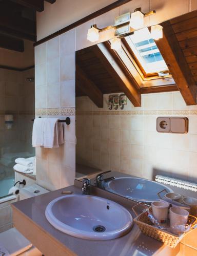 a bathroom with a sink and a tub at Hotel Rantiner in Taüll