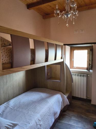 a bedroom with a bunk bed and a chandelier at Casa vacanza da GIGI in Calascio