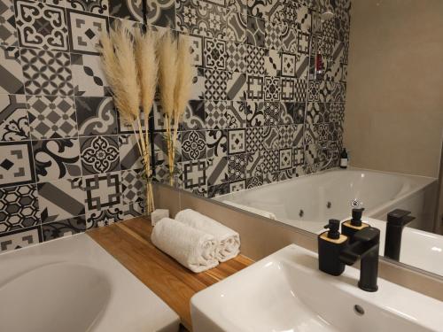 a bathroom with a white sink and a bath tub at 74SUITE Sibenik - Self check in - Garage in Šibenik