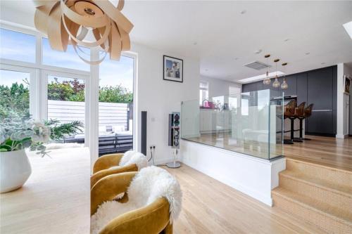 a living room with a staircase and a glass counter at Mincarlo House in St Austell