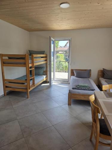 a room with two bunk beds and a patio at Little Break 2, Nähe Legoland in Röfingen