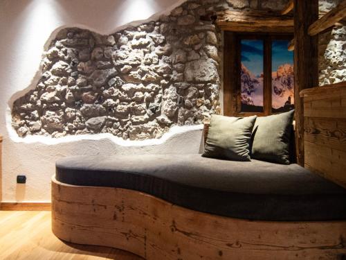 a bedroom with a bed made out of a log at Alla Frasca Verde in Lauco
