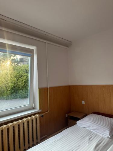 a bedroom with a bed and a window at Helska Ostoya in Hel