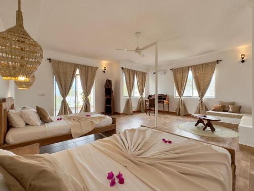 a large living room with two beds and a couch at Shirley Boutique Hotel in Kiwengwa