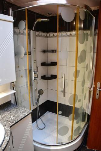 a shower with a glass door in a bathroom at Red House Retreat Aegina Kontos in Kondós