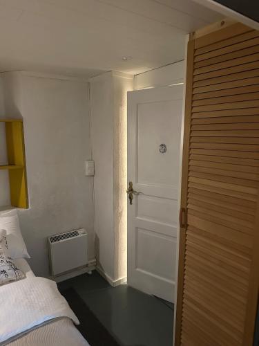 a bedroom with a bed and a white door at Fantastic Apartment Tromsø Two in Tromsø