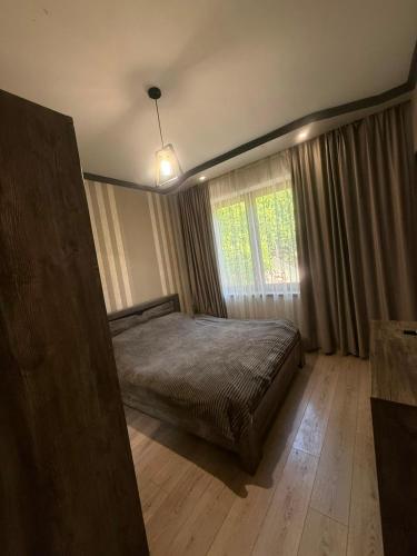 a bedroom with a bed and a window at home 4 room in Yerevan