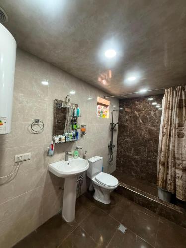 a bathroom with a white toilet and a sink at home 4 room in Yerevan