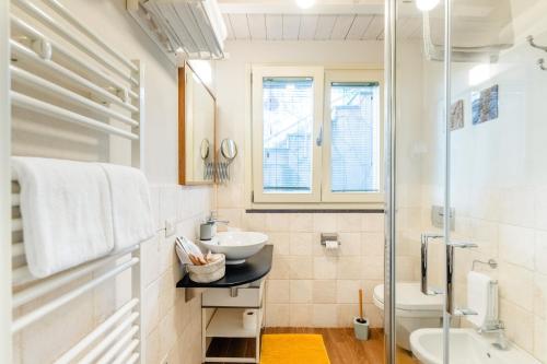 a white bathroom with a sink and a shower at B&B Kapì Country in Alghero