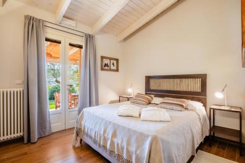 a bedroom with a large bed and a window at B&B Kapì Country in Alghero