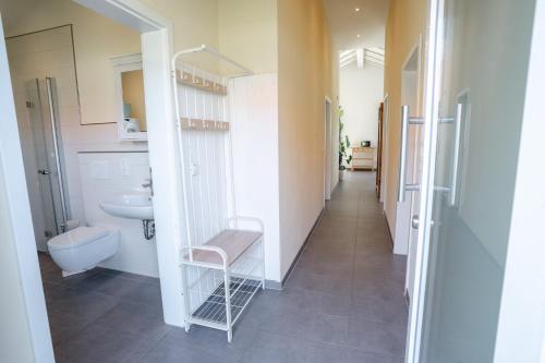 a small bathroom with a sink and a toilet at Haus Freija in Sehestedt