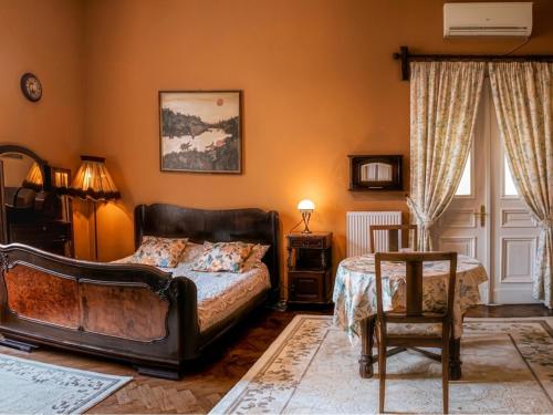 a bedroom with a bed and a chair at Willa Wiluszówka in Dębica