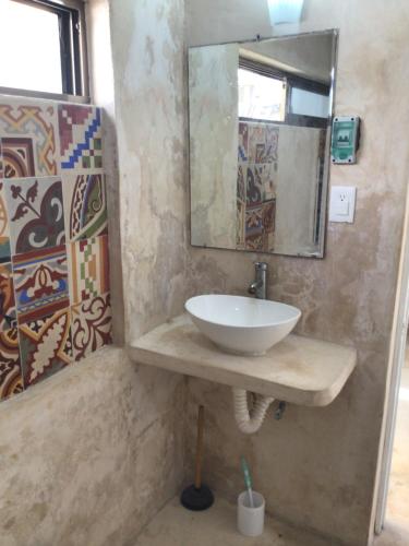a bathroom with a sink and a mirror at Paz y Mar in Chelem