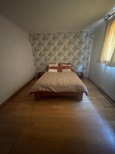 a bedroom with a bed and a wall at Belle vue étoilée in Saint-Ouen