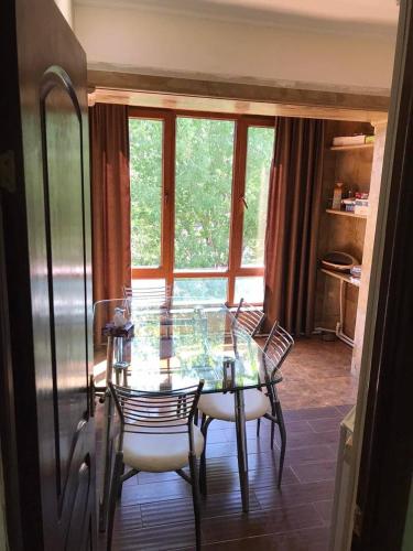 a dining room with a glass table and chairs at Jermuk in Jermuk