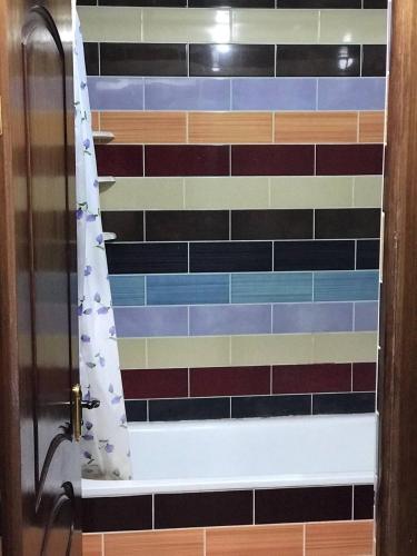 a bathroom with a shower curtain in a room at Jermuk in Jermuk