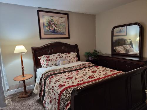 a bedroom with a bed and a large mirror at Home Sweet Home in Red Deer