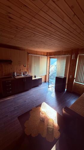 a large room with a kitchen and a table at House on Fontan in Odesa