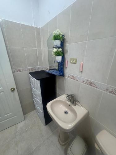 a small bathroom with a sink and a toilet at Apto Próximo al Aeropuerto Gregorio Luperón in Puerto Plata
