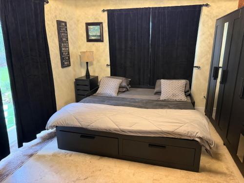 a bedroom with a large bed with a black headboard at Homestay Weston Ranches in Southwest Ranches
