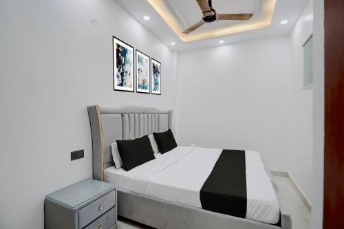 a bedroom with a bed with black and white sheets at Hotel O Bay Inn in New Delhi