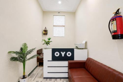 a living room with a couch and a tv at Hotel O Moonlight Residency in Noida