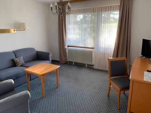 a living room with a couch and a table at Pension Panorama in Hitzacker