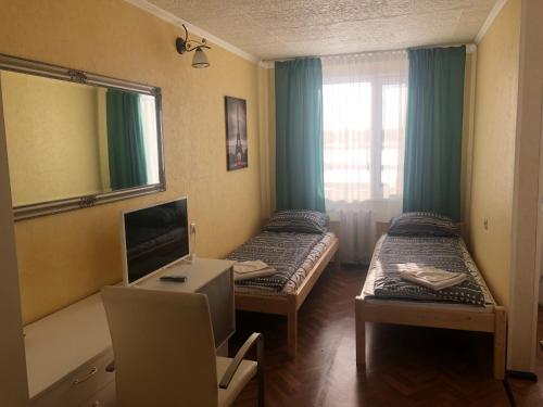 a small room with two beds and a mirror at Campsite Jelgava in Jelgava