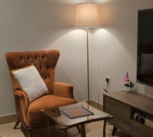 a living room with a chair and a coffee table at Khobar Luxury Apartments in Al Khobar