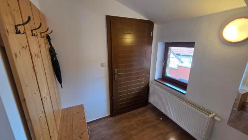 a hallway with a door and a window at PARADAJS City Center Apartments - 24h self check-in & free private parking in Spišská Nová Ves