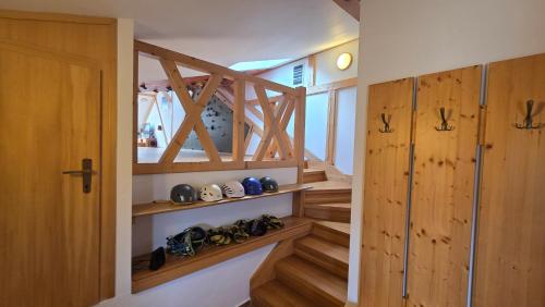 a staircase in a house with wooden doors and shoes at PARADAJS City Center Apartments - 24h self check-in & free private parking in Spišská Nová Ves