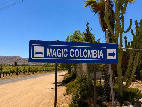 a blue street sign on the side of a road at Magic Colombia in El Porvenir