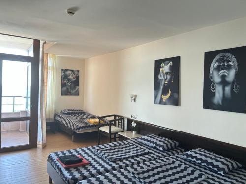 a hotel room with two beds and a room with at Sozopol Sunrise A in Sozopol